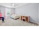 Light-filled bedroom with carpet, light pink walls, bed with decorative pillows, desk, and chair at 158 Balsam Cir, Summerville, SC 29485