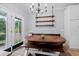 Bright breakfast nook offers views of the backyard and has a rustic wooden table and modern light fixture at 158 Balsam Cir, Summerville, SC 29485