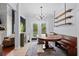 Cozy breakfast nook is flooded with light and features a stylish chandelier and bench seating at 158 Balsam Cir, Summerville, SC 29485
