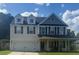 Charming two-story home with front porch, garage, shuttered windows and landscaped front yard at 158 Balsam Cir, Summerville, SC 29485