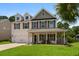 Charming two-story home with a welcoming front porch and manicured lawn at 158 Balsam Cir, Summerville, SC 29485
