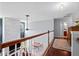 Second floor hallway with hardwood floors, white railing, and views of the living room at 158 Balsam Cir, Summerville, SC 29485