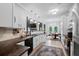 Bright kitchen features white cabinets, granite countertops, modern appliances, and an adjacent breakfast area at 158 Balsam Cir, Summerville, SC 29485