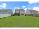 Large backyard with green grass, a fence, and a screened porch at 158 Netherfield Dr, Summerville, SC 29486