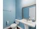 Well-lit half bathroom featuring modern fixtures, wood look flooring, and a pedestal sink at 158 Netherfield Dr, Summerville, SC 29486