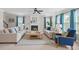 Spacious living room with a fireplace, comfortable seating, and ample natural light from large windows at 158 Netherfield Dr, Summerville, SC 29486