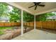 The covered back patio provides backyard views with a ceiling fan and fountain at 1629 Jorrington Street St, Mount Pleasant, SC 29466