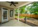 Covered back patio with ceiling fan, traditional columns, and view of the fenced backyard at 1629 Jorrington Street St, Mount Pleasant, SC 29466