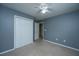 Bedroom featuring neutral carpet, gray walls, a closet with bi-fold doors, and a white ceiling fan at 1629 Jorrington Street St, Mount Pleasant, SC 29466