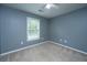 A light and airy bedroom offers a ceiling fan, neutral walls and carpet, and a bright window at 1629 Jorrington Street St, Mount Pleasant, SC 29466