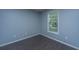 Cozy bedroom features a window offering outdoor views, complementing the hardwood floors and neutral wall color at 1629 Jorrington Street St, Mount Pleasant, SC 29466