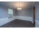 Charming dining room features elegant wainscoting, modern chandelier, and hardwood floors, bathed in natural light at 1629 Jorrington Street St, Mount Pleasant, SC 29466