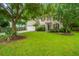 Charming two-story home with beige siding, red shutters, a well-manicured lawn, and a two-car garage at 1629 Jorrington Street St, Mount Pleasant, SC 29466