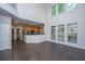 Open concept living room with hardwood floors, tall windows, and eat in kitchen at 1629 Jorrington Street St, Mount Pleasant, SC 29466