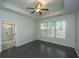 Bright main bedroom boasts a tray ceiling, ceiling fan, and an ensuite bathroom at 1629 Jorrington Street St, Mount Pleasant, SC 29466
