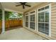 Covered back patio with tan vinyl siding and a ceiling fan. The floor is painted gray at 1629 Jorrington Street St, Mount Pleasant, SC 29466