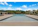Large community pool with tanning chairs and shady gazebos surrounded by landscaped green trees at 1629 Jorrington Street St, Mount Pleasant, SC 29466