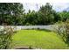 Spacious backyard offering green grass and a white fence for privacy at 1630 Mermentau St, Mount Pleasant, SC 29466