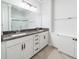 Bright bathroom with granite countertop, double sinks, storage and a glass-enclosed shower at 1630 Mermentau St, Mount Pleasant, SC 29466