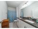 Bathroom with double sinks, granite countertops and a tiled shower behind a patterned curtain at 1630 Mermentau St, Mount Pleasant, SC 29466
