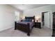 Cozy bedroom with a dark wood bed frame, nightstands, and lamps, creating a relaxing and comfortable retreat at 1630 Mermentau St, Mount Pleasant, SC 29466