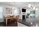 Charming dining area with wood table, stylish chandelier, and cozy fireplace, perfect for Gathering meals and entertaining at 1630 Mermentau St, Mount Pleasant, SC 29466