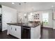 Open-concept dining room with a farmhouse table, adjacent to a living area and bright windows at 1630 Mermentau St, Mount Pleasant, SC 29466