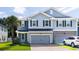 Charming two-story home features a well-maintained lawn, gray siding and attached two-car garage at 1630 Mermentau St, Mount Pleasant, SC 29466