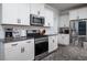 Well-equipped kitchen showcases stainless steel appliances, white cabinets, and granite countertops at 1630 Mermentau St, Mount Pleasant, SC 29466