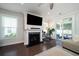 Comfortable living room with a fireplace, TV, and sliding glass doors, offering a relaxing and bright space at 1630 Mermentau St, Mount Pleasant, SC 29466
