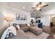 Inviting living room with a large sectional sofa, plush rug, and an open layout leading to the kitchen area at 1630 Mermentau St, Mount Pleasant, SC 29466
