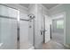 This tiled shower features glass doors, built in shower caddy and sleek chrome fixtures at 1630 Mermentau St, Mount Pleasant, SC 29466