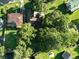 Aerial view showcasing a well-maintained property with lush landscaping, a private driveway, and mature trees at 1807 Perch Rd, Moncks Corner, SC 29461