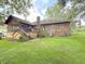 Brick home featuring a large deck and screened porch, overlooking a lush green backyard at 1807 Perch Rd, Moncks Corner, SC 29461