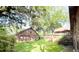Backyard view of brick detached garage with beautiful green grass at 1807 Perch Rd, Moncks Corner, SC 29461