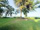 Manicured backyard with expansive green lawn and mature trees overlooking the waterway at 1807 Perch Rd, Moncks Corner, SC 29461