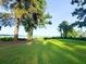 Lush backyard with sprawling green lawn shaded by mature trees overlooking scenic waterway at 1807 Perch Rd, Moncks Corner, SC 29461