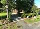 Charming home with manicured landscaping, a paved driveway, and a 'For Sale' sign at 1807 Perch Rd, Moncks Corner, SC 29461