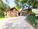 Charming brick home boasts an attached two-car garage and a spacious driveway, all nestled under lush, mature trees at 1807 Perch Rd, Moncks Corner, SC 29461