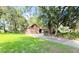 Charming brick home with an attached garage and beautiful landscaping, enhanced by the natural beauty of mature trees at 1807 Perch Rd, Moncks Corner, SC 29461