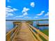 Waterfront property featuring a long wooden pier with a gazebo and boat dock under a partly cloudy sky at 1807 Perch Rd, Moncks Corner, SC 29461