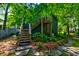 Backyard showing stairs leading to home, beautiful plants and stone pavers at 1872 Staffwood Rd, Johns Island, SC 29455
