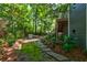 Landscaped backyard featuring a stone pathway and greenery, with seating and stairs at 1872 Staffwood Rd, Johns Island, SC 29455