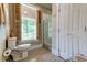 Bathroom featuring a vanity, toilet, glass enclosed shower and a window with wooden shutters at 1872 Staffwood Rd, Johns Island, SC 29455