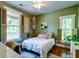 Inviting bedroom with two windows providing natural light, hardwood floors, and stylish decor at 1872 Staffwood Rd, Johns Island, SC 29455