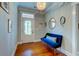 Inviting entryway with hardwood floors, stylish blue bench, and decorative mirrors at 1872 Staffwood Rd, Johns Island, SC 29455