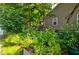 Beautiful garden area with vibrant flowering plants, lush greenery, and mature trees, showcasing the home's landscaping at 1872 Staffwood Rd, Johns Island, SC 29455