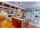Gourmet kitchen with island, hardwood floors, open to the living room, and designer light fixtures at 1872 Staffwood Rd, Johns Island, SC 29455