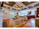 Spacious living room featuring an open concept, coffered ceilings, hardwood floors, and modern finishes at 1872 Staffwood Rd, Johns Island, SC 29455