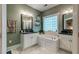 Main bathroom featuring double vanity, a separate tub and a glass block window for natural light and added privacy at 1872 Staffwood Rd, Johns Island, SC 29455